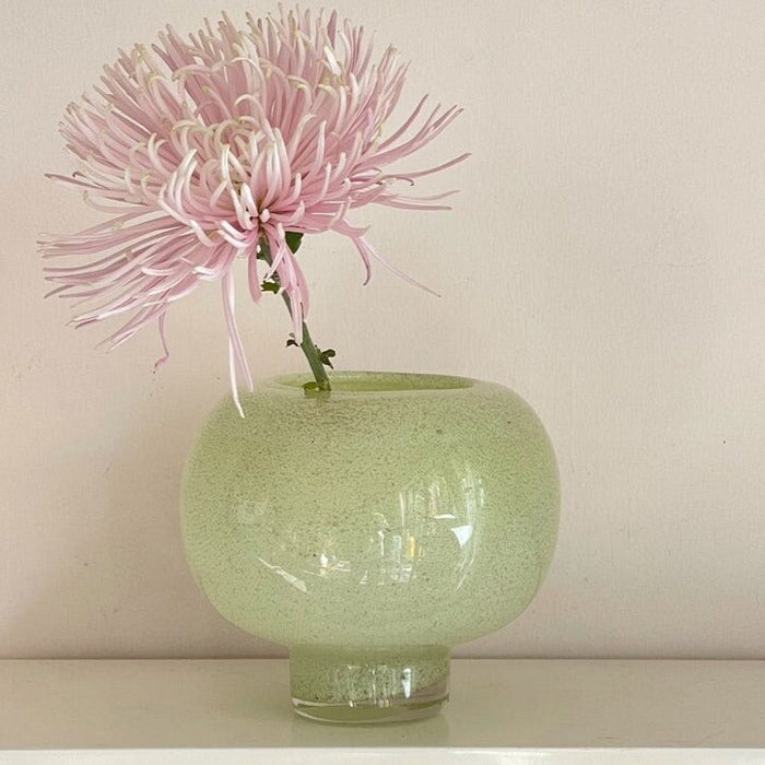 Green round glass vase for flowers and home decor