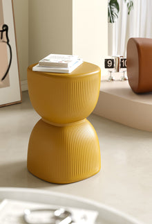 Yellow striped plastic stool and plant stand for home decor