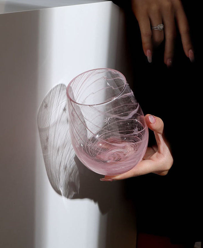Starry pink glass cup with decorative star pattern