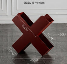 Orange X-shaped metal bookshelf for books, magazines, and home decor