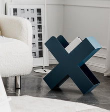 Orange X-shaped metal bookshelf for books, magazines, and home decor