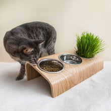 Wooden elevated pet bowl stand with three stainless steel bowls in oak finish