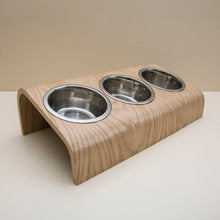 Wooden elevated pet bowl stand with three stainless steel bowls in oak finish