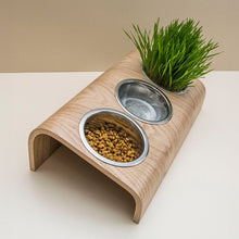 Wooden elevated pet bowl stand with three stainless steel bowls in oak finish