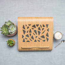 Oak wooden laptop stand with ventilation cutouts for a desk workspace