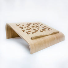 Oak wooden laptop stand with ventilation cutouts for a desk workspace
