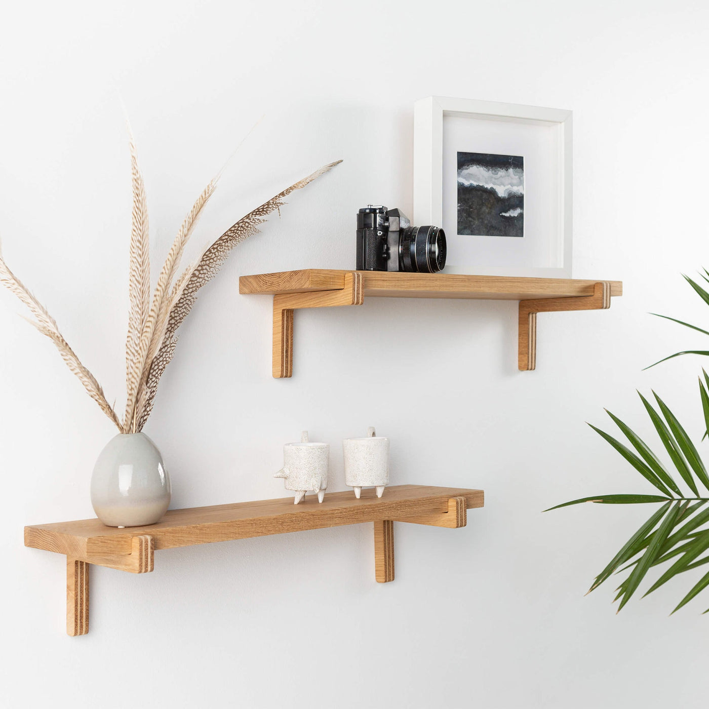 Set of two natural oak floating wall shelves with holders for home or office display