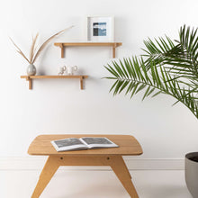 Set of two natural oak floating wall shelves with holders for home or office display